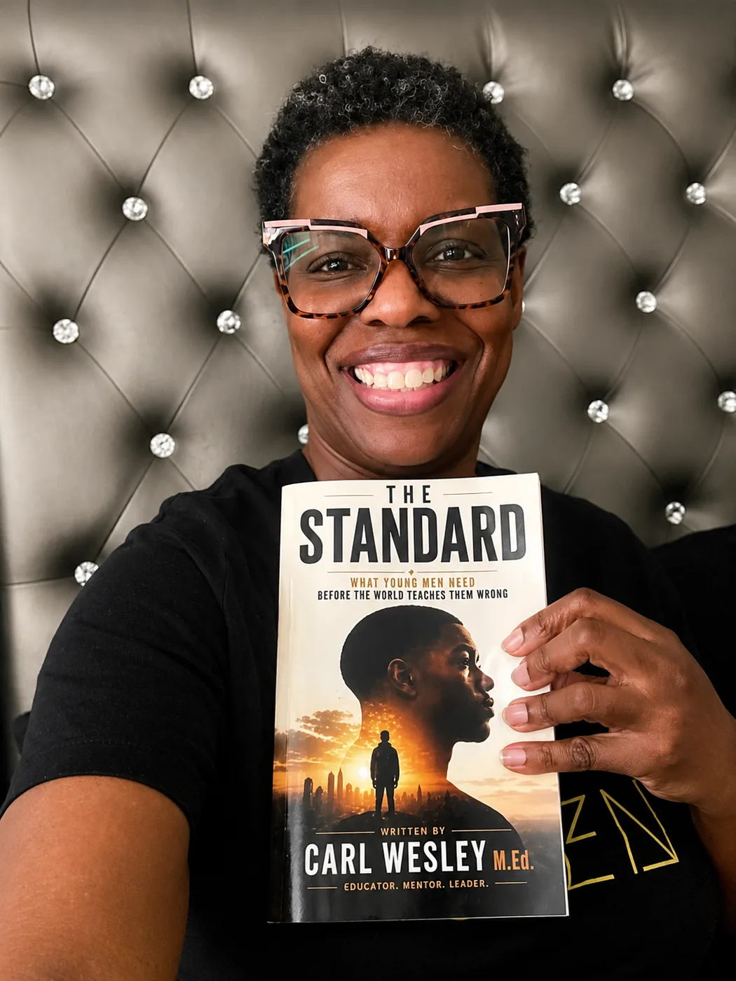 Reader holding The Standard by Carl Wesley