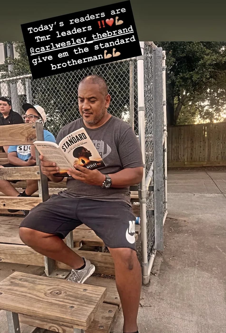 Reader holding The Standard by Carl Wesley