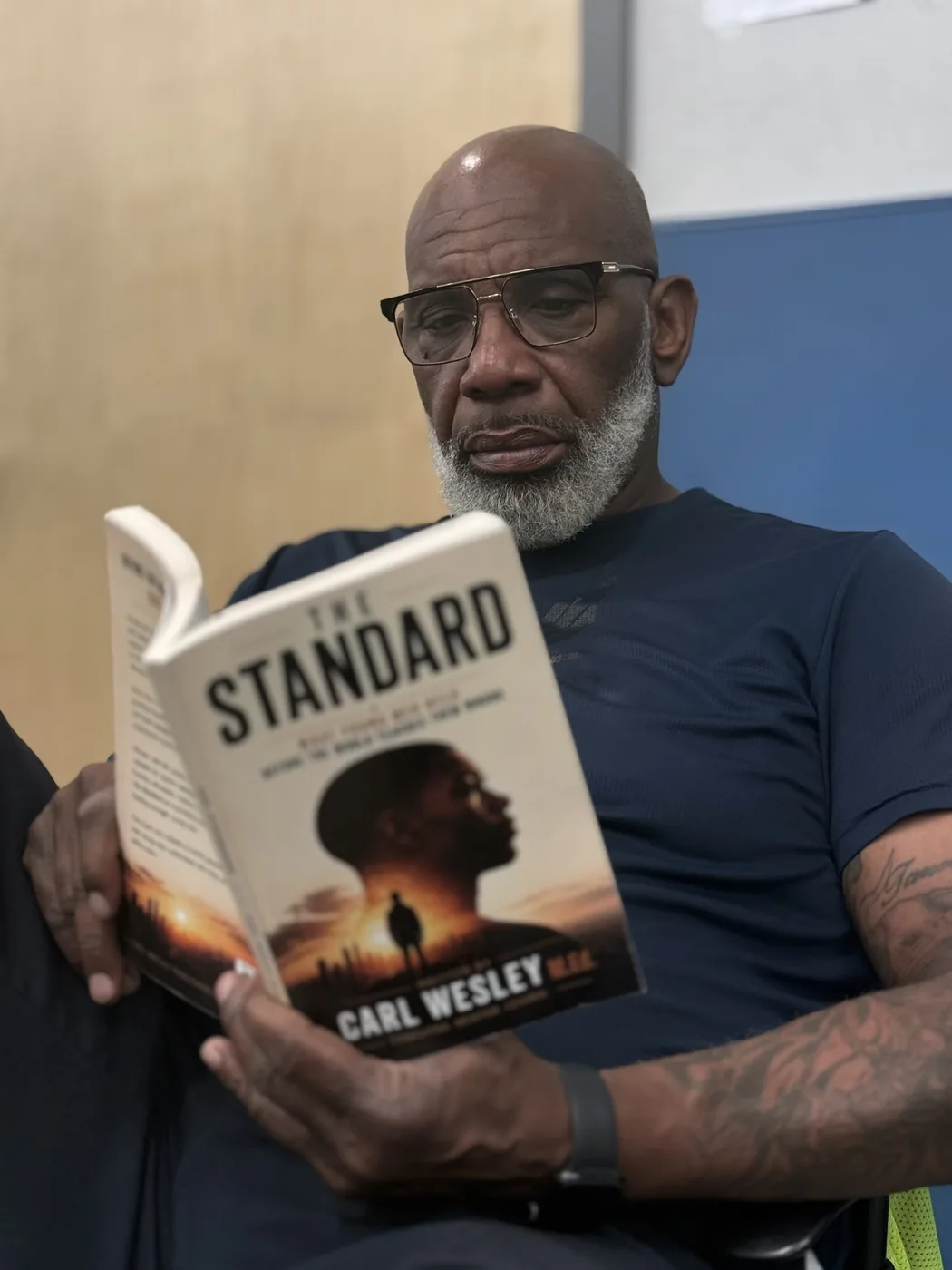 Reader holding The Standard by Carl Wesley