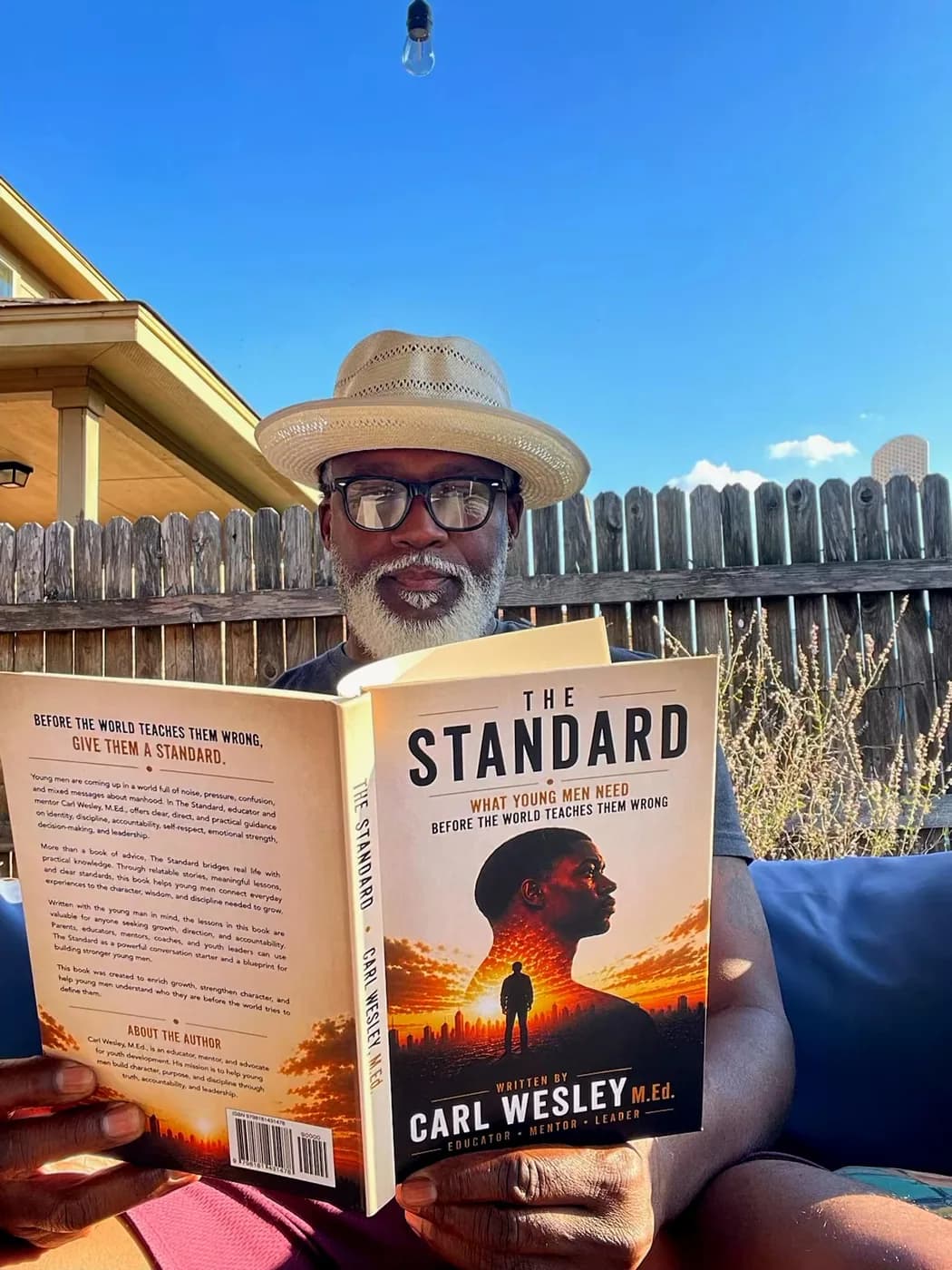 Reader holding The Standard by Carl Wesley