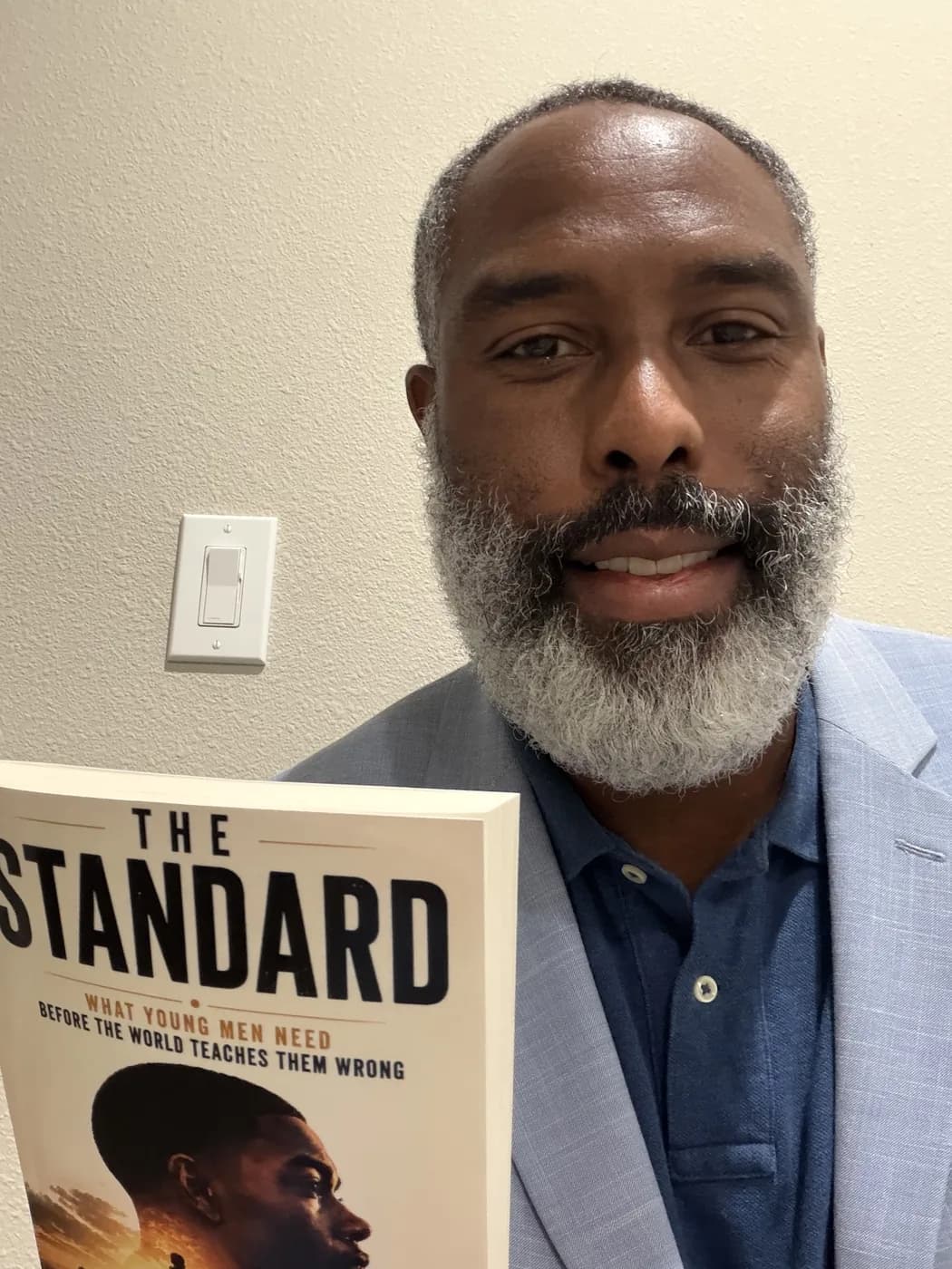 Reader holding The Standard by Carl Wesley
