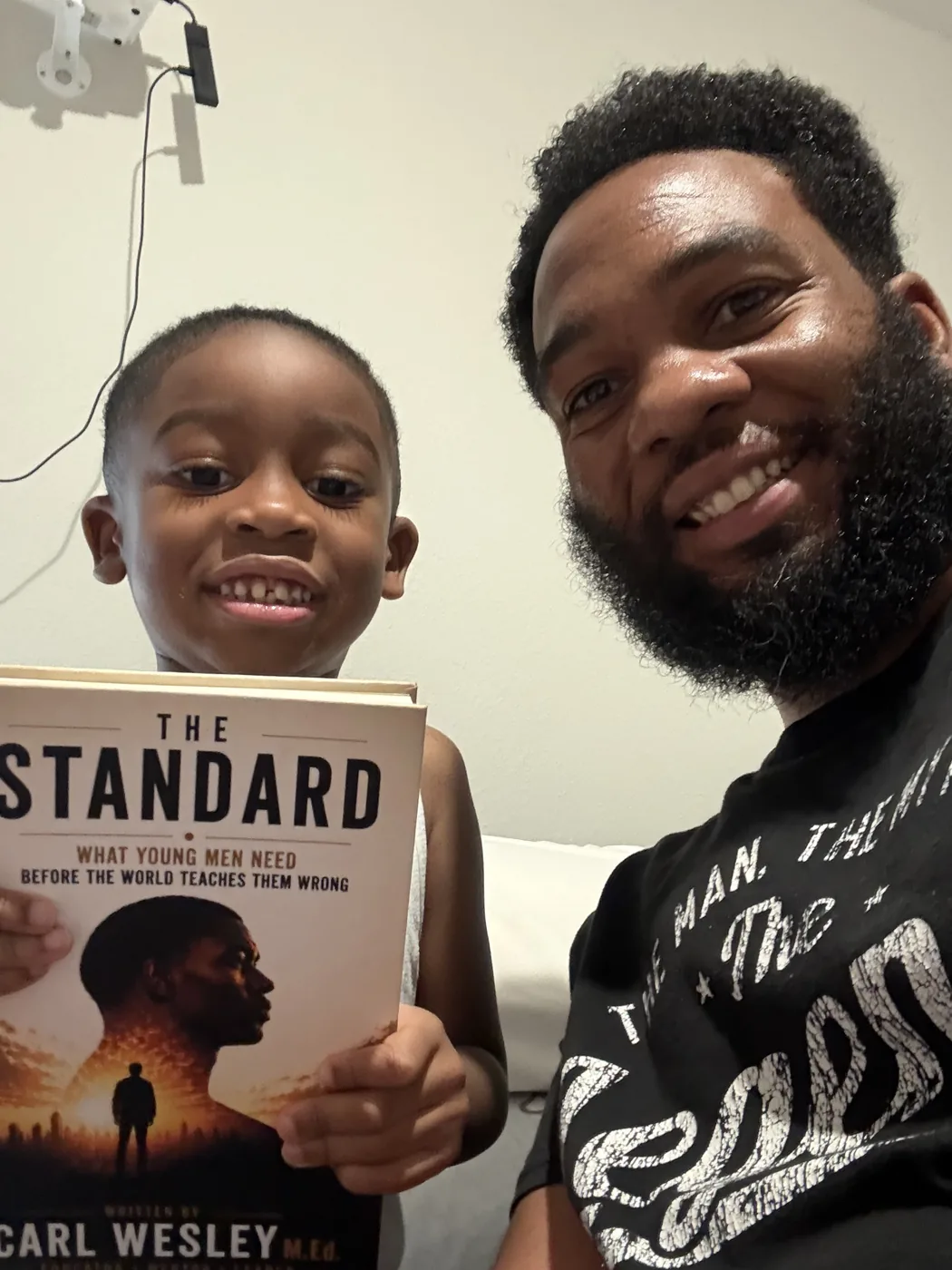 Reader holding The Standard by Carl Wesley