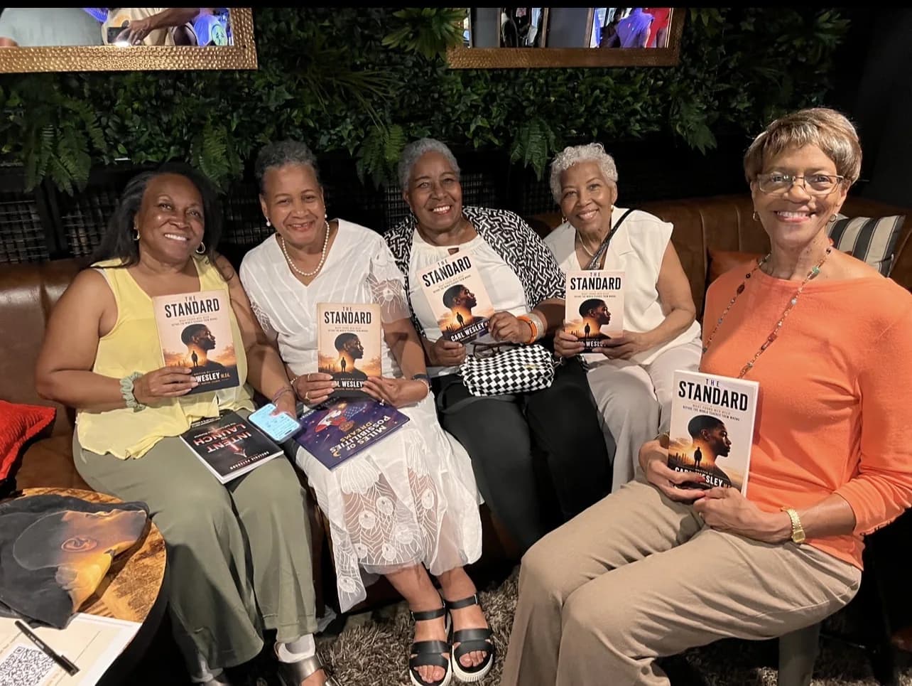 Readers holding The Standard by Carl Wesley