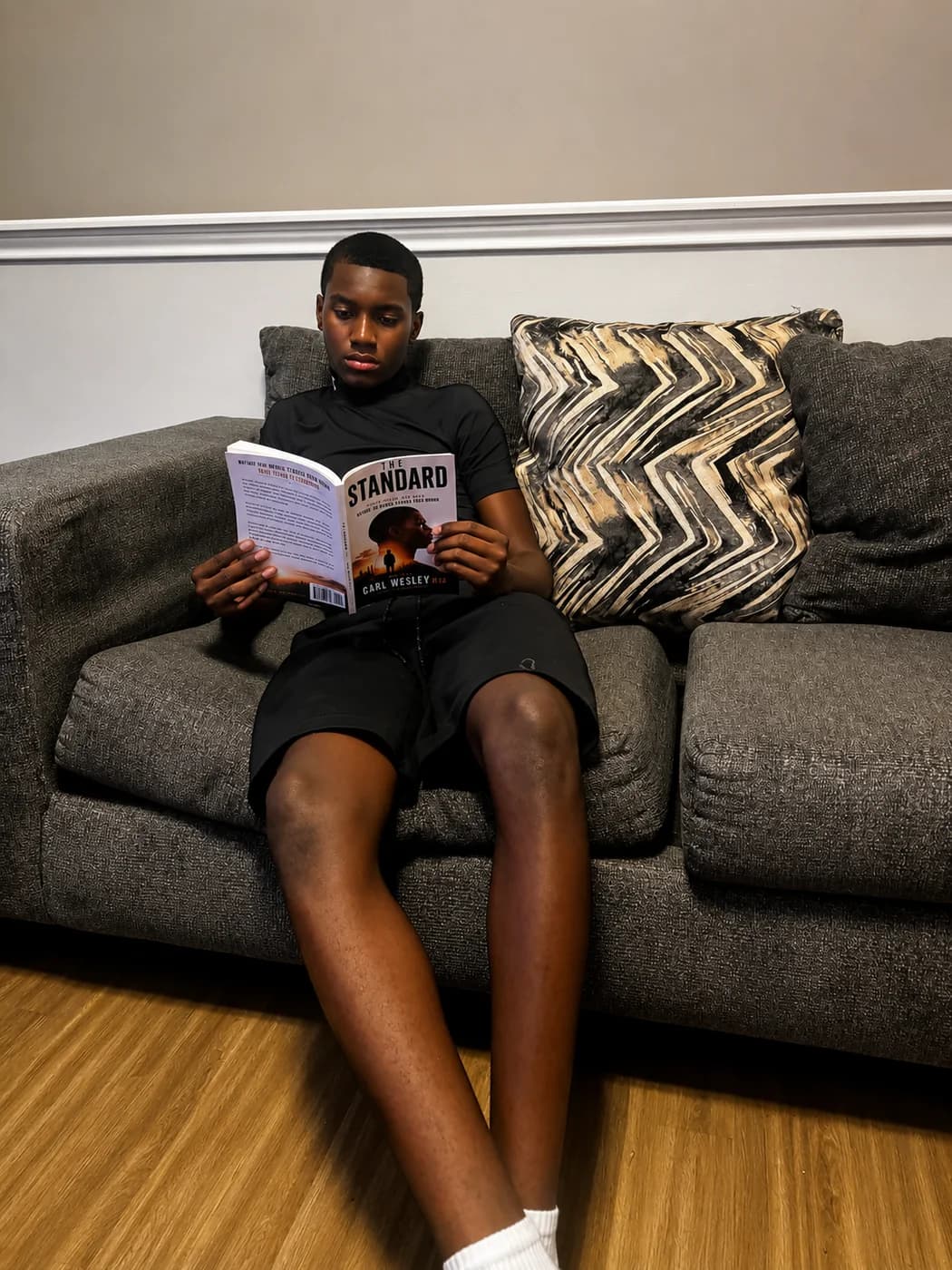 Young reader reading The Standard by Carl Wesley
