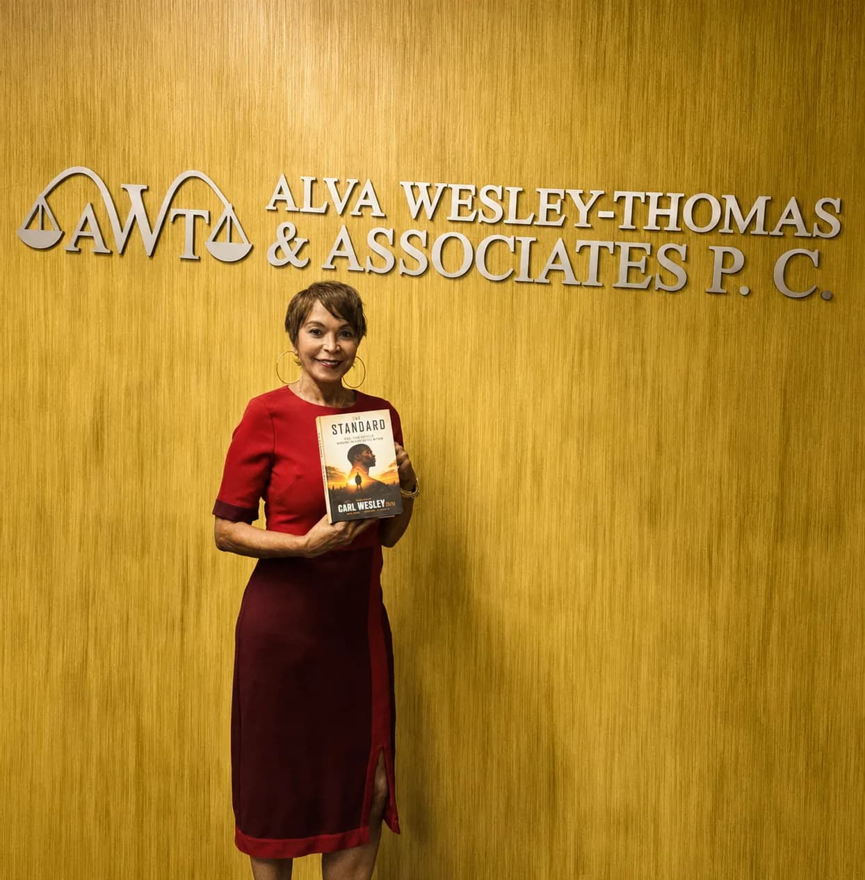 Community supporter holding The Standard by Carl Wesley