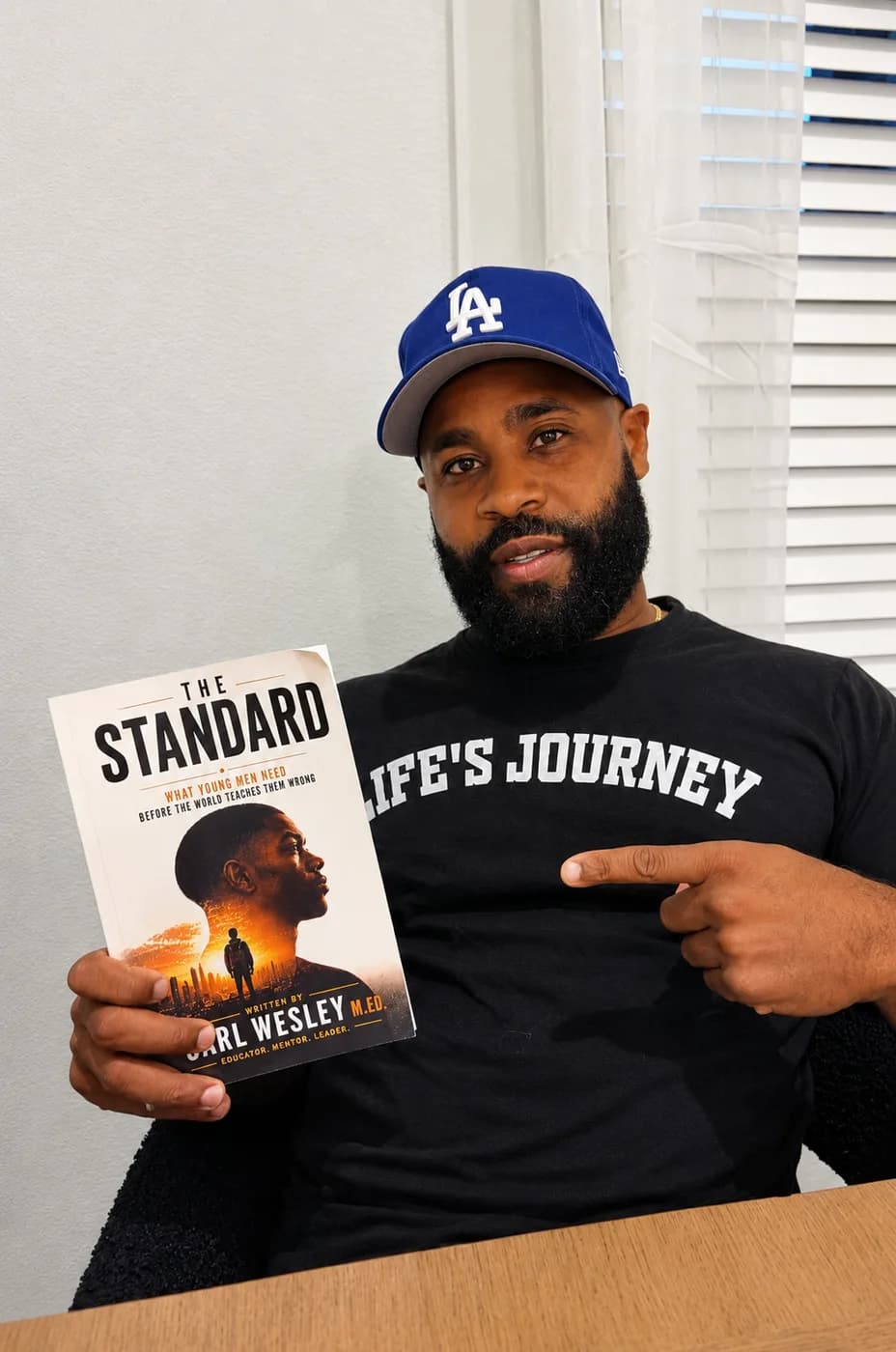 Reader holding The Standard by Carl Wesley